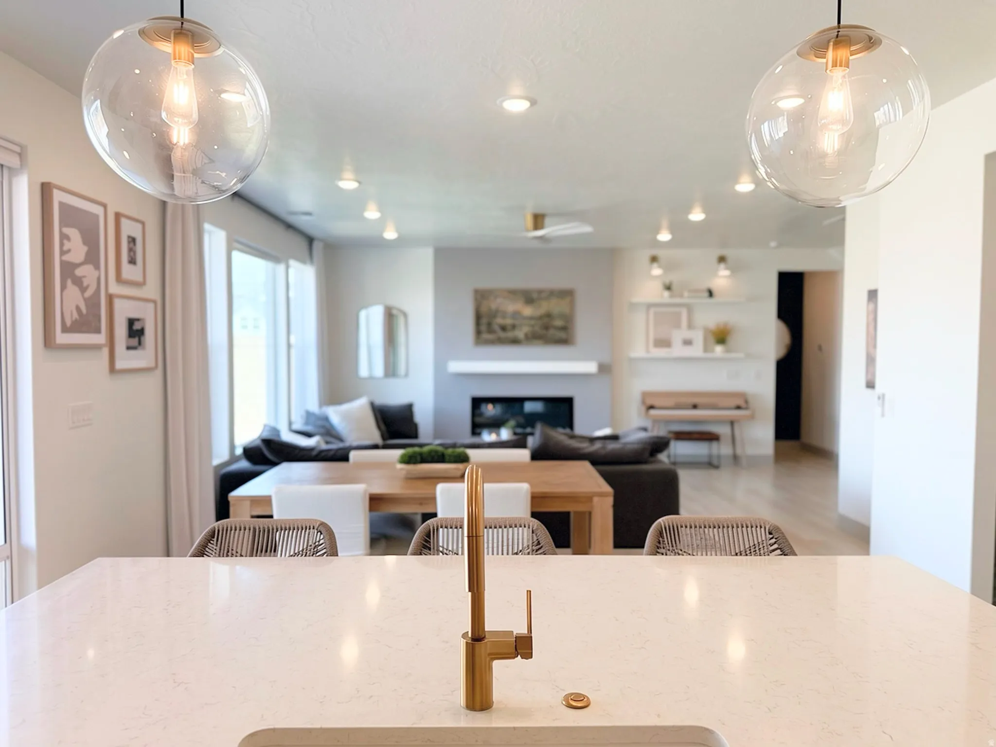 Kitchen island featuring a gold-finish faucet and light-toned countertop
