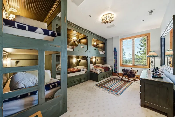 Custom built-in bunk beds with individual lighting fixtures and integrated storage drawers