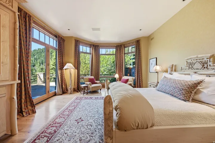 Hardwood flooring throughout featuring a large area rug