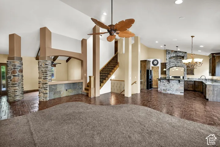 Stone accents throughout, featuring an open-concept living area with a textured carpeted section and a patterned tile floor