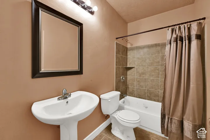 Bathroom featuring a pedestal sink, framed mirror, and chrome fixtures