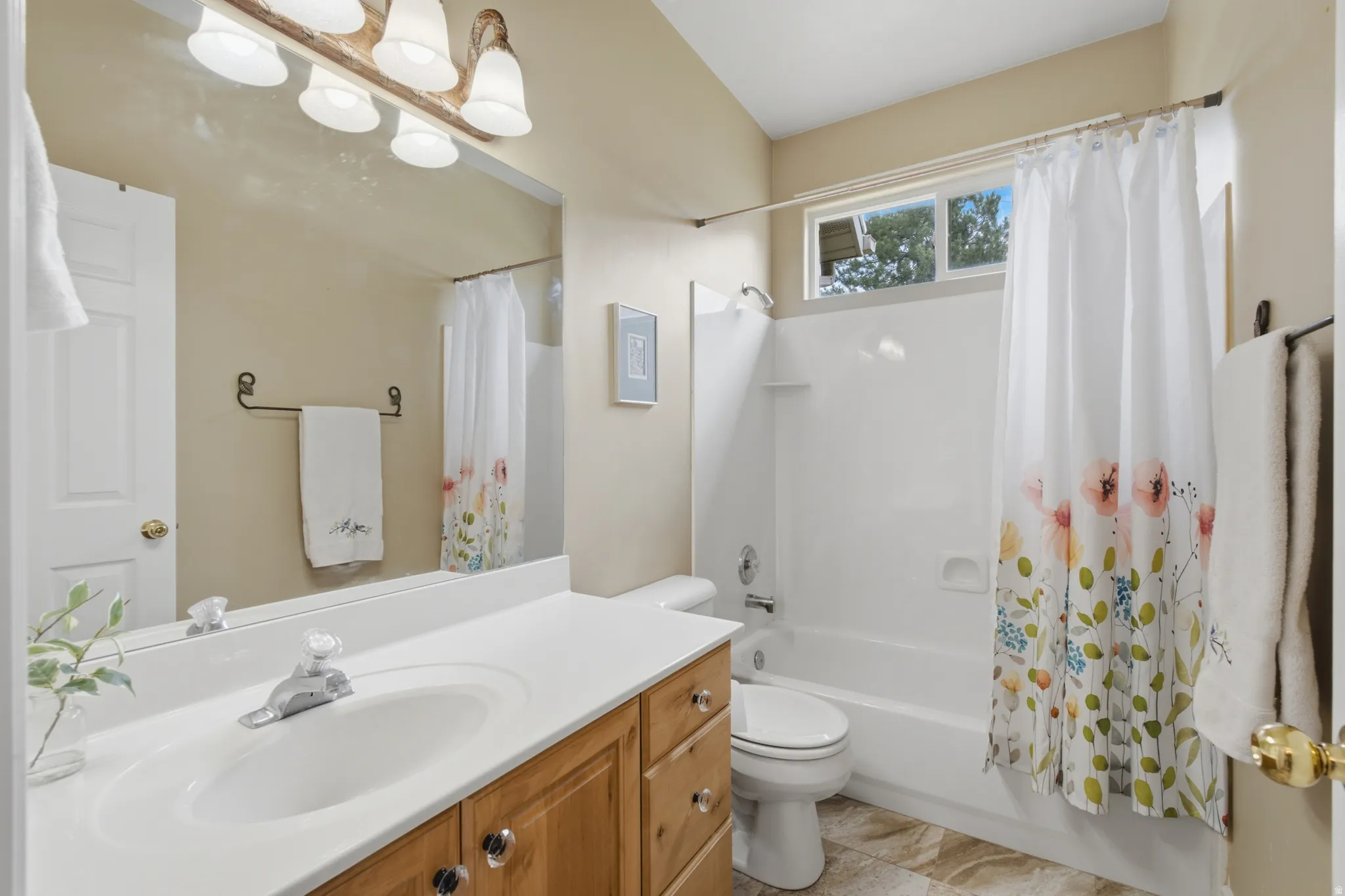 Full bathroom featuring a single vanity with wood cabinetry, a white countertop, and an integrated sink
