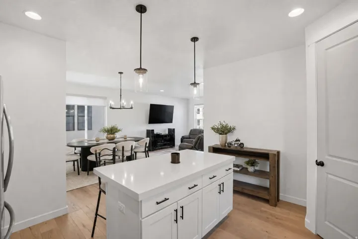 Kitchen island with a white countertop and dark hardware