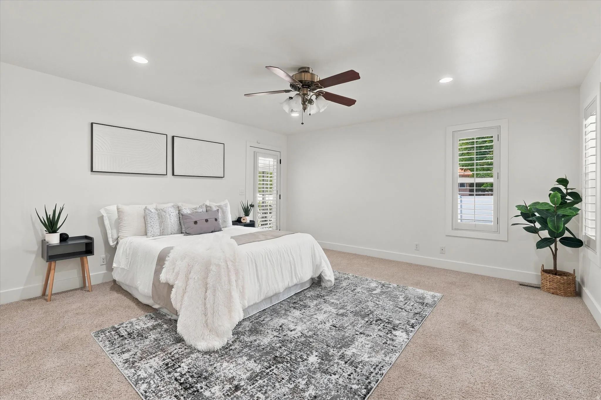 Spacious room with plush carpeting, recessed lighting, and a ceiling fan