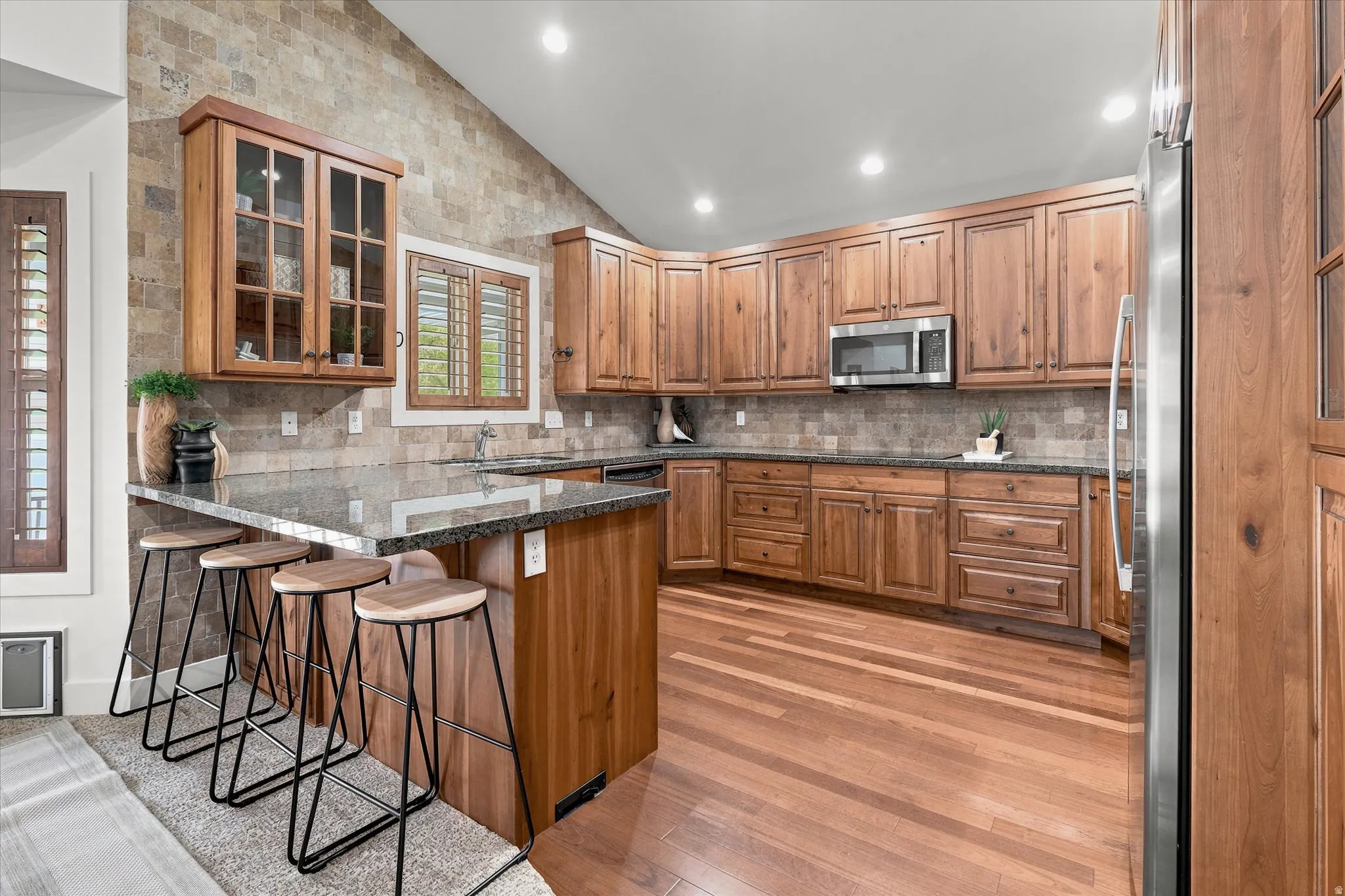 Kitchen featuring wood-finish cabinetry, granite countertops, and stainless steel appliances