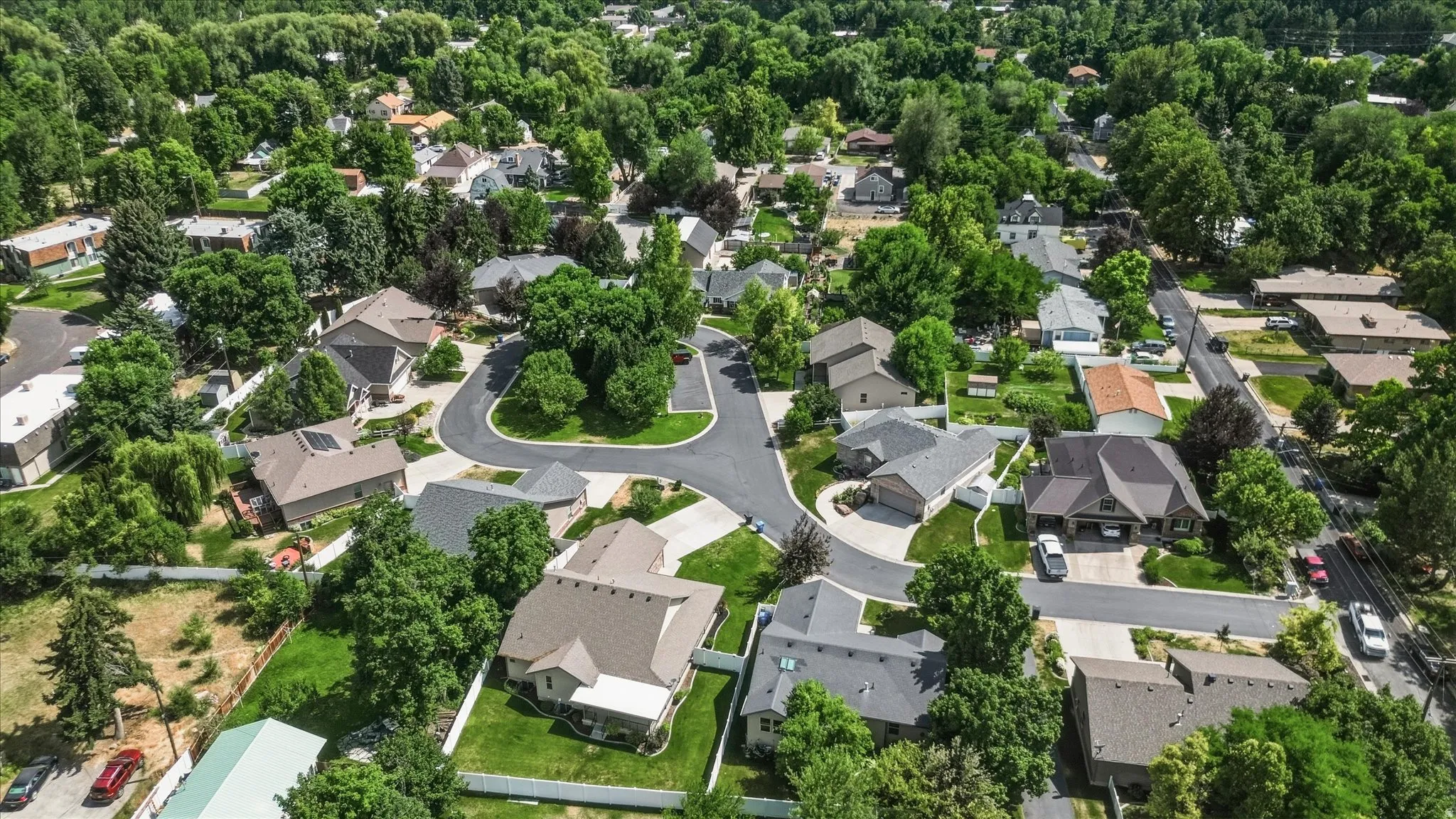Aerial perspective highlighting a residential community with mature trees and established landscaping
