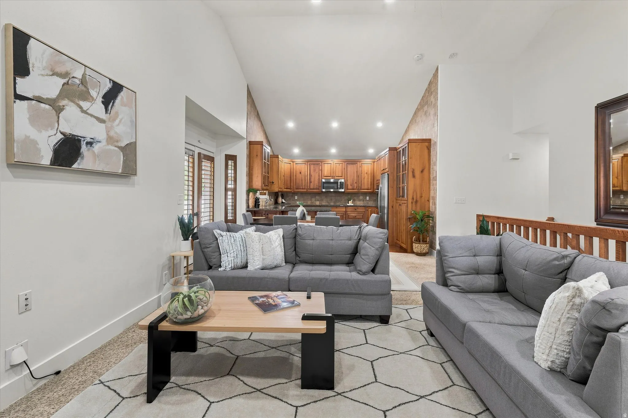 Vaulted ceilings illuminate the living area with recessed lighting