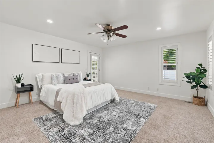 Spacious room with plush carpeting, recessed lighting, and a ceiling fan
