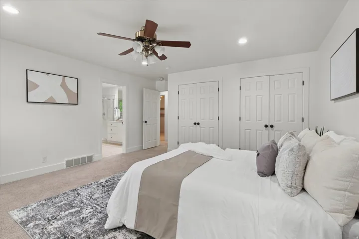 Carpeted room with white walls, recessed lighting, and a ceiling fan with light fixture