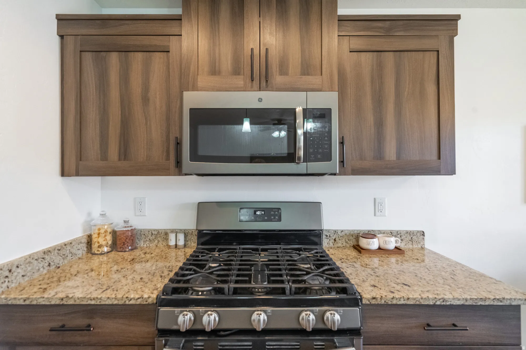 Stainless steel gas range with coordinating microwave