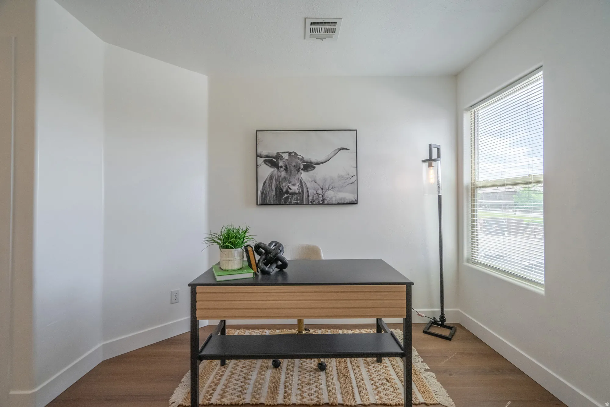 Room with a large window and wood-finish flooring