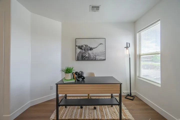 Room with a large window and wood-finish flooring