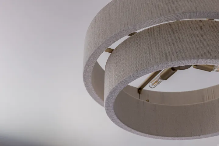 Contemporary ceiling light fixture featuring dual fabric-wrapped rings and exposed Edison-style bulbs