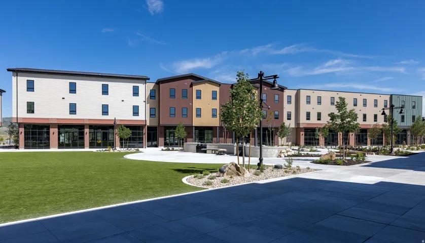 Contemporary multi-story buildings featuring varied color palettes and fenestration