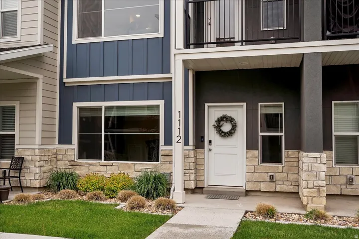 Modern facade featuring a combination of horizontal siding, vertical board and batten, and stone veneer accents