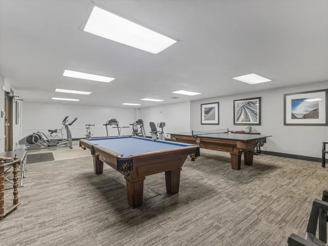 Recreational space featuring a billiard table, ping pong table, and various exercise equipment
