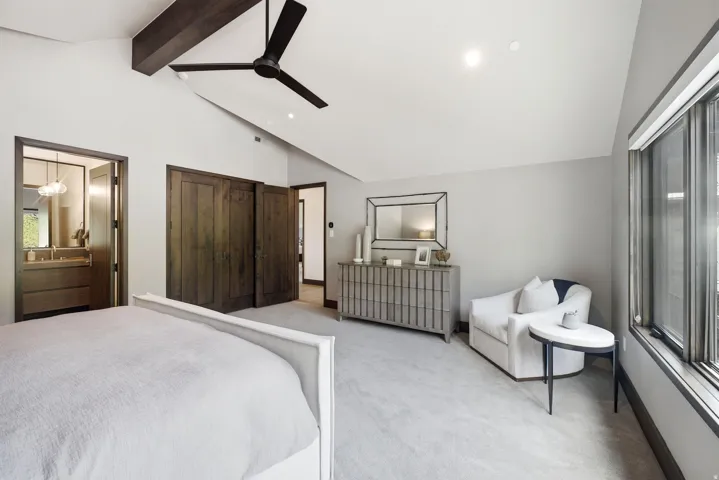 Vaulted ceiling with exposed wood beam and modern ceiling fan