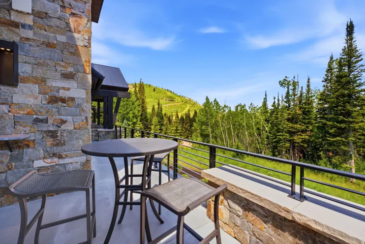 Stone exterior wall featuring an integrated outdoor sconce