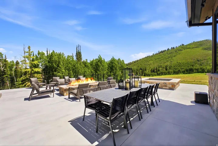 Expansive concrete patio offering multiple outdoor seating areas