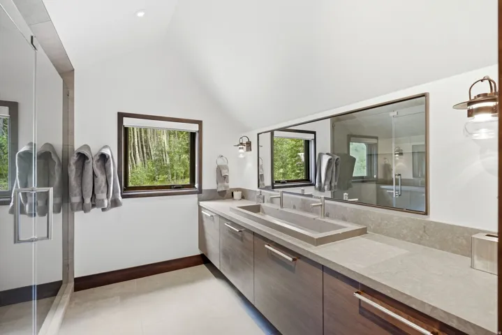 Modern bathroom featuring a double vanity with integrated rectangular sink and light grey countertop