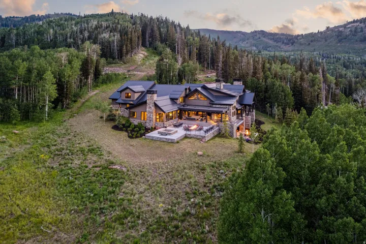 Expansive mountain estate featuring a multi-level stone and wood-clad exterior