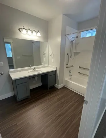 Bathroom featuring a vanity with a white countertop and a single basin sink
