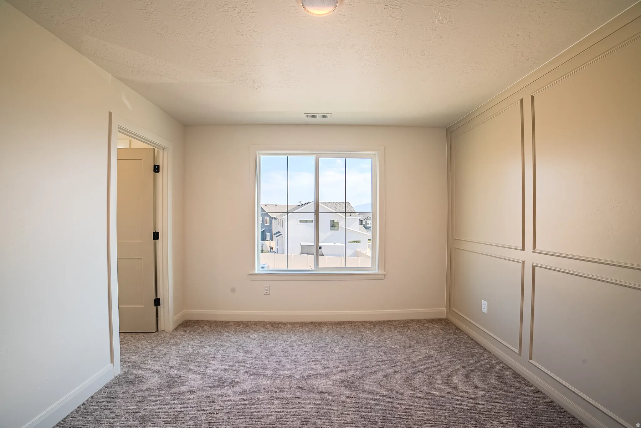 Window-paneled accent wall with recessed lighting