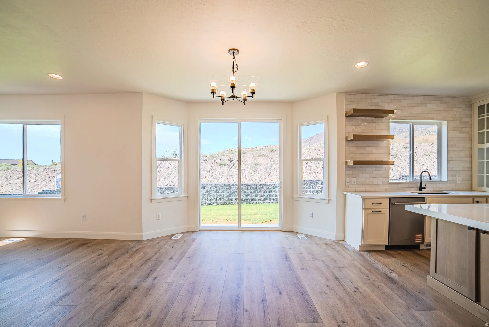 Open concept living area with wood-finish flooring
