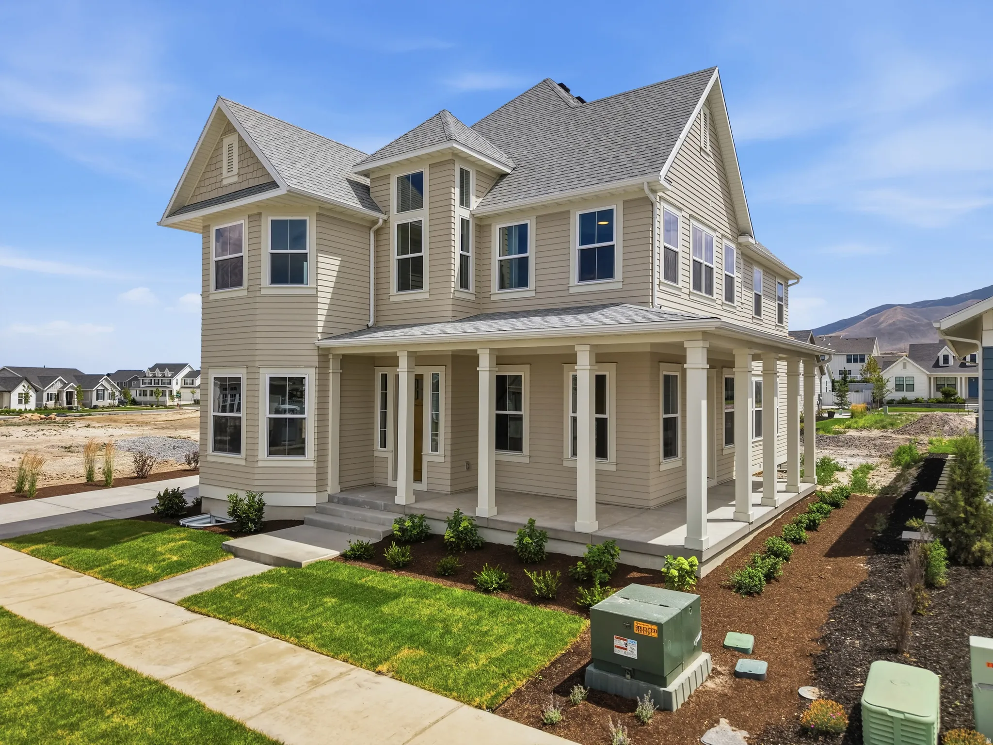 Two-story residence featuring light beige siding and a gray shingle roof