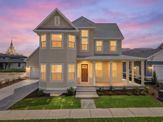 Two-story residence featuring light siding and a prominent bay window