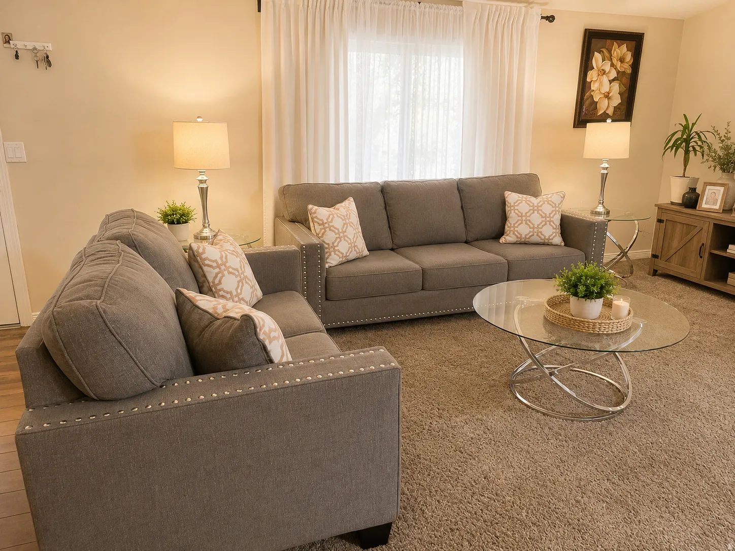 Carpeted living area featuring light-toned walls, sheer window treatments, and recessed lighting