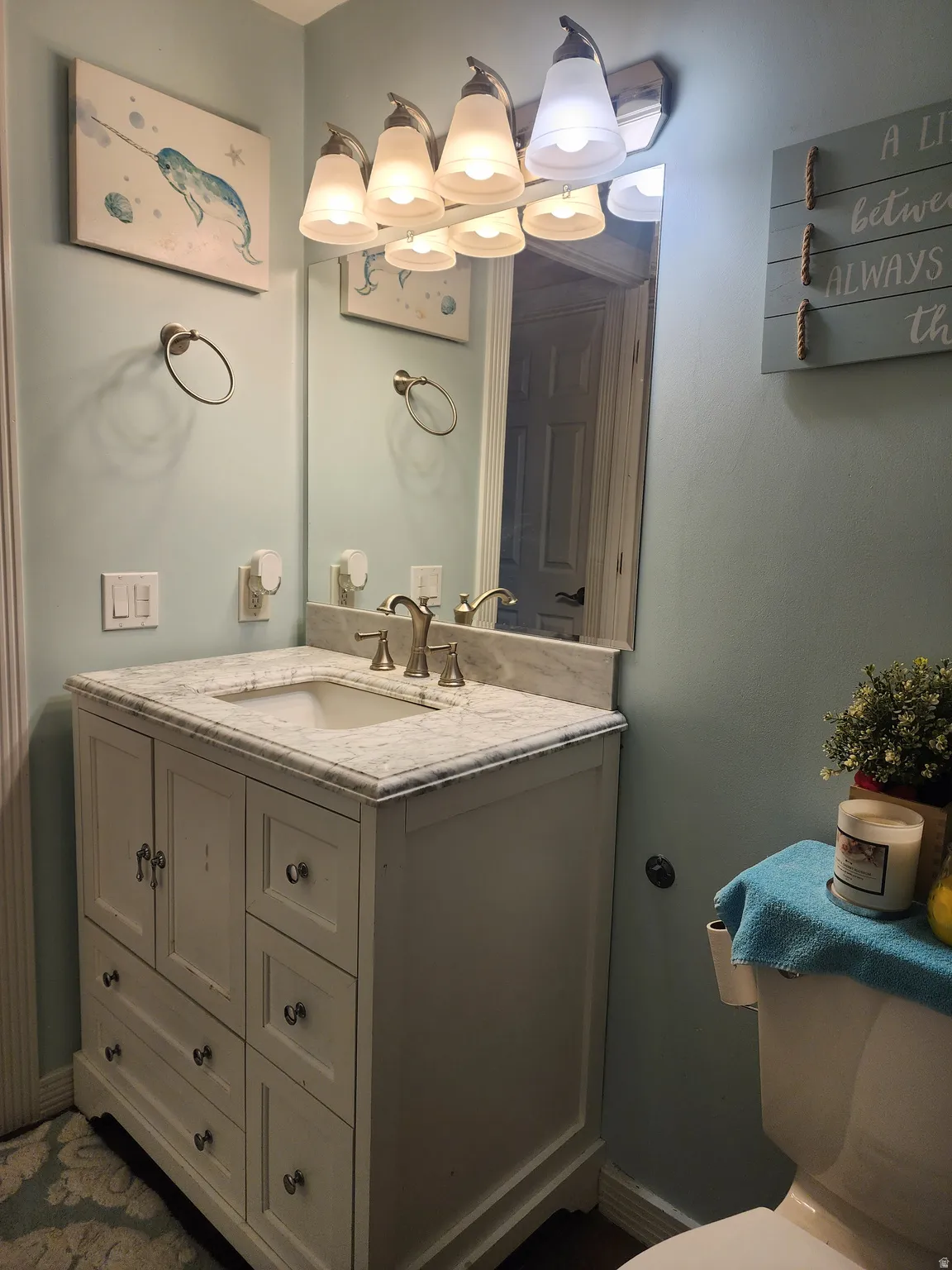White vanity with integrated sink and marble countertop