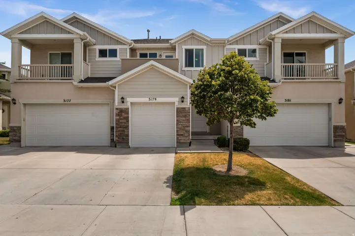 Contemporary multi-unit residence featuring neutral stucco and siding exteriors
