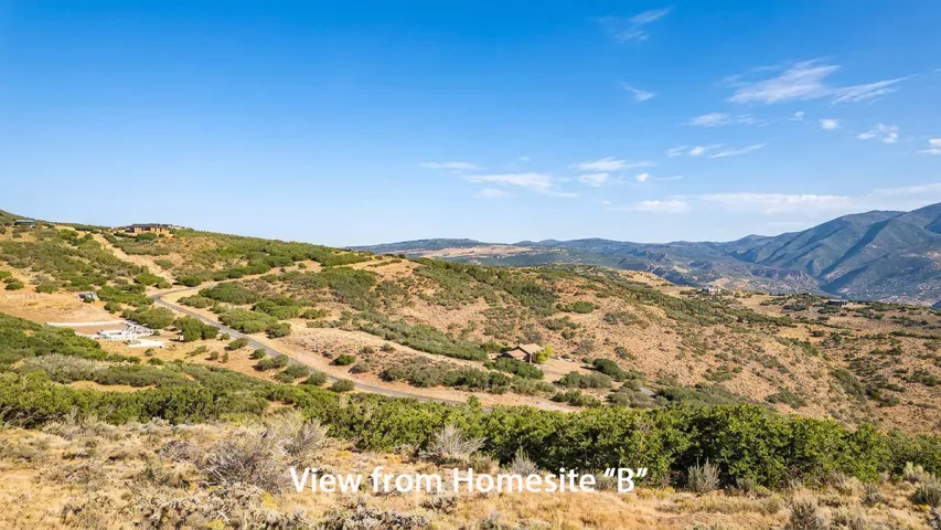 Expansive mountain landscape with rolling hills and abundant natural foliage
