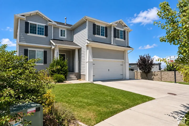 Two-story residence with light gray siding and black window shutters