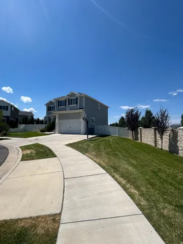 Two-story residential structure with light blue siding and white trim