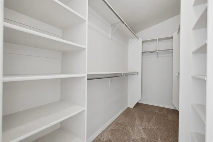 Primary bedroom walk-in closet