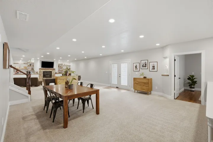 Spacious interior featuring recessed lighting and light-toned carpeting throughout