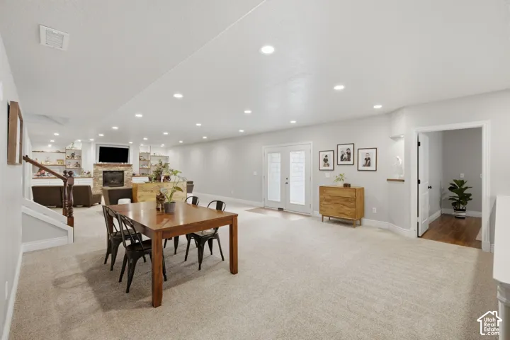 Spacious interior featuring recessed lighting and light-toned carpeting throughout