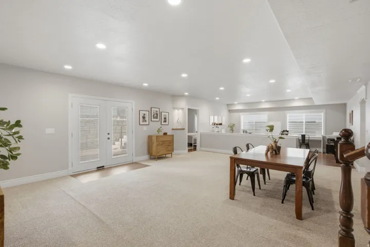 Spacious lower-level room featuring recessed lighting and light-toned carpet flooring