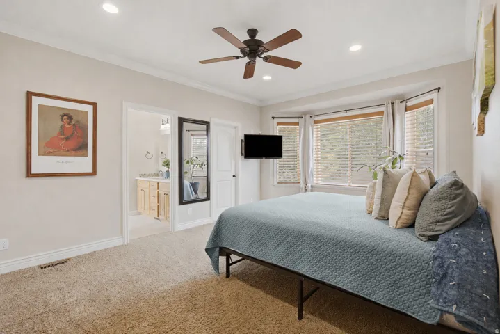 Bedroom featuring a bay window with blinds, recessed lighting, and a ceiling fan