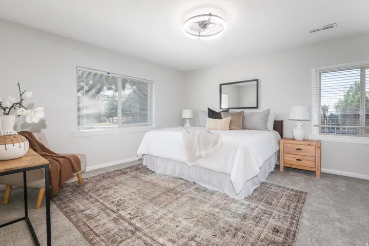 Bedroom featuring light gray carpeting and white walls