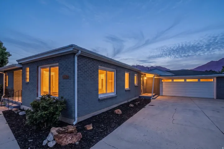 Brick exterior residence featuring a single-car garage with transom windows