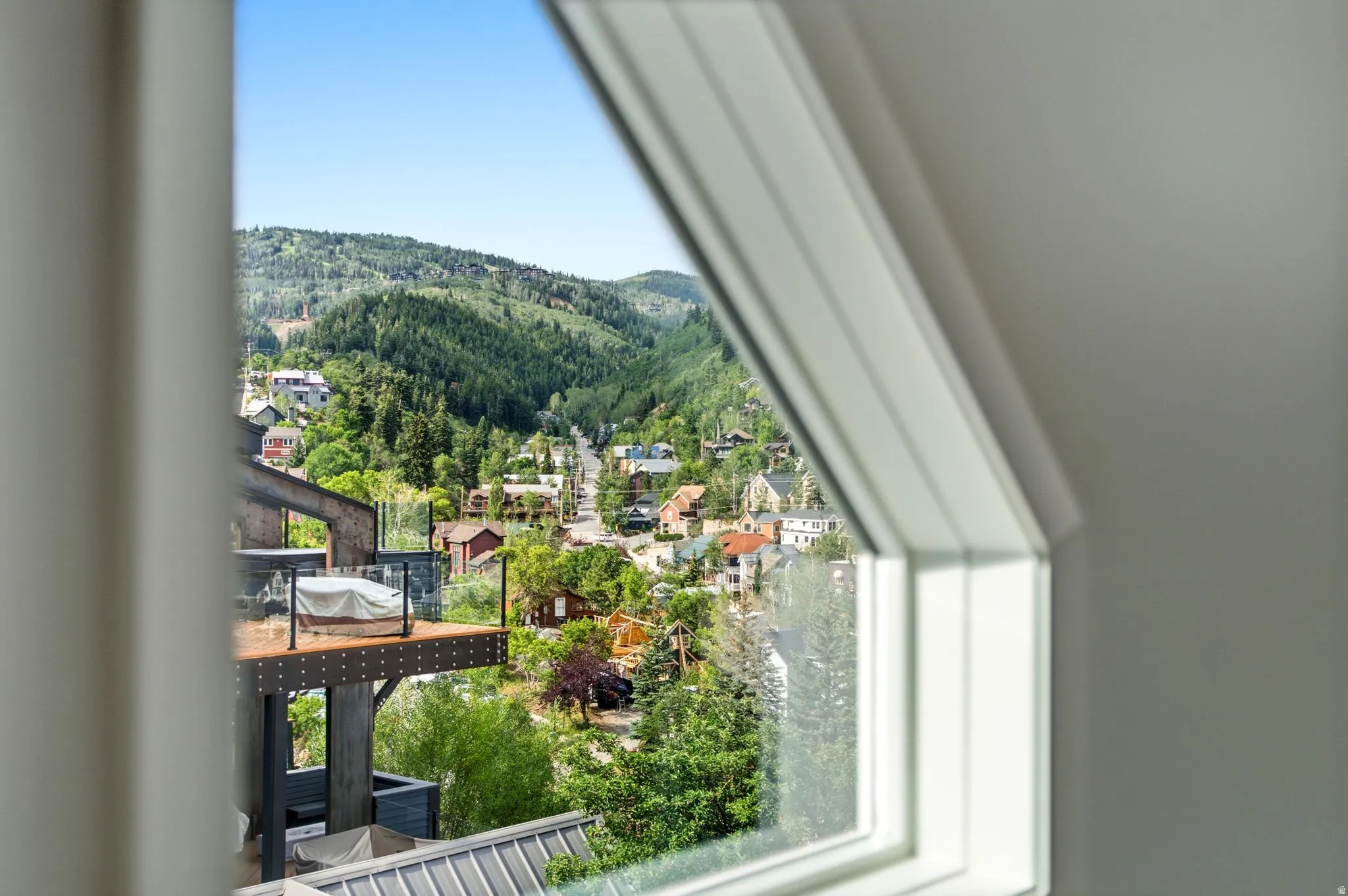 Expansive mountain and community scenery visible through a framed window