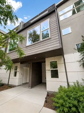 Contemporary multi-level exterior with horizontal wood-finish siding and stucco accents