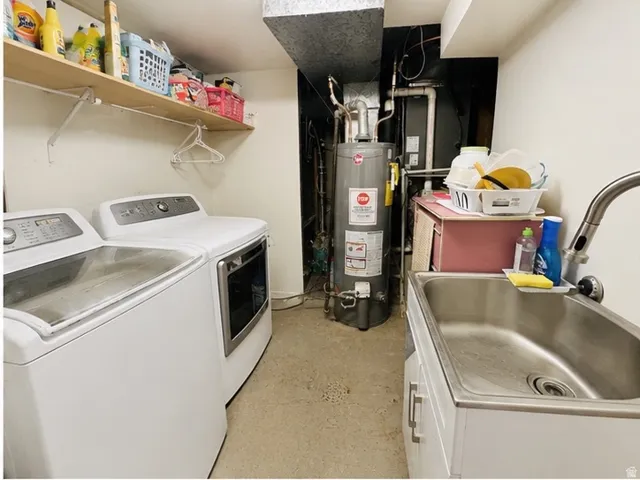 Dedicated utility space featuring a stainless steel utility sink with a gooseneck faucet, a water heater, and exposed overhead ductwork. Washer and dryer not included on sale.
