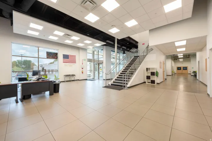 Spacious lobby featuring large format tile flooring and extensive natural light from a full-height window wall