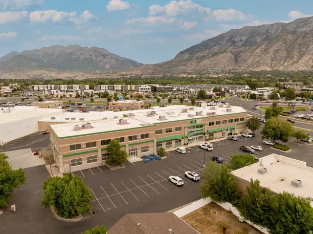 Two-story commercial building with an expansive paved parking lot