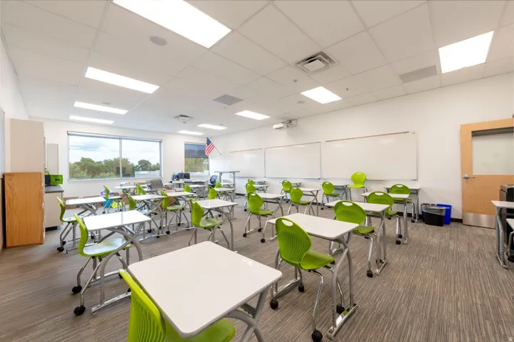 Spacious interior featuring a neutral color palette, recessed lighting, and large windows