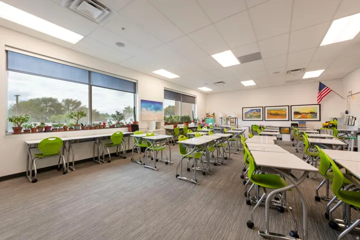 Spacious interior featuring a large window, recessed lighting, drop ceiling, and broadloom carpet